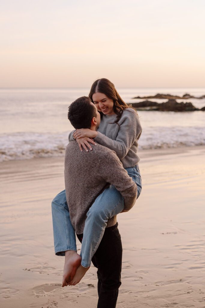 Cozy couples outfits for a chilly engagement session on the beach at sunset