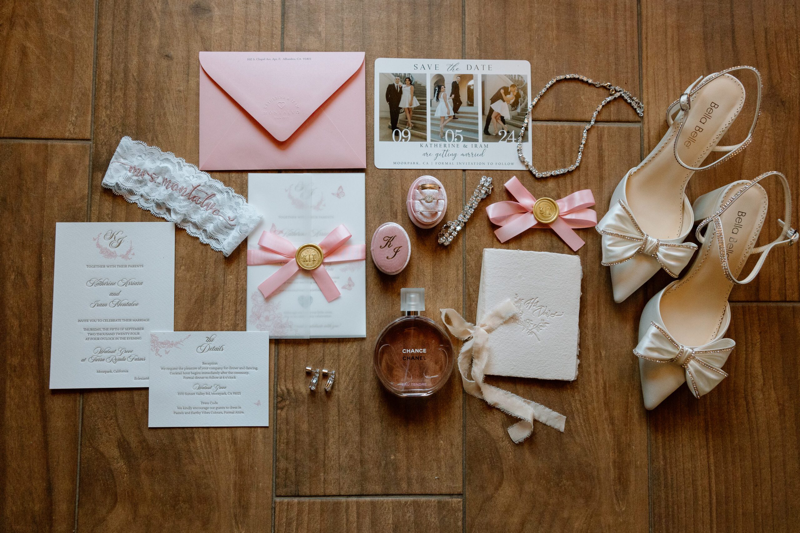 Wedding flat lay photograph featuring the bride's shoes, a picture frame, perfume, rings, earrings, and flowers