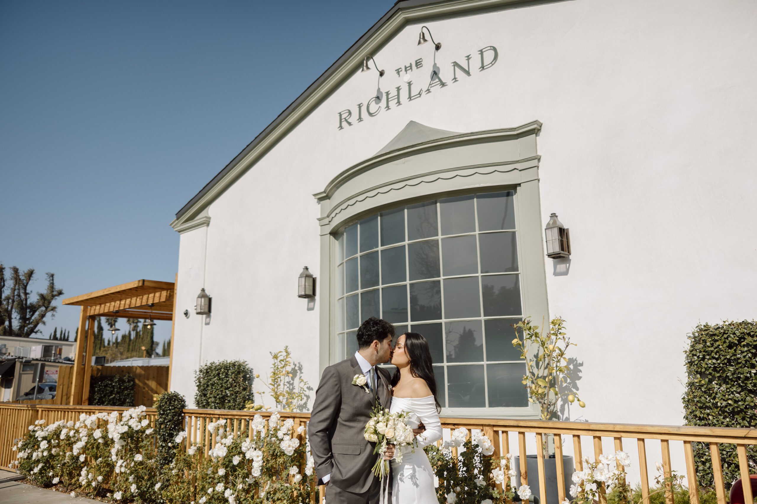 Wedding couple kissing outside The Richland in Orange California